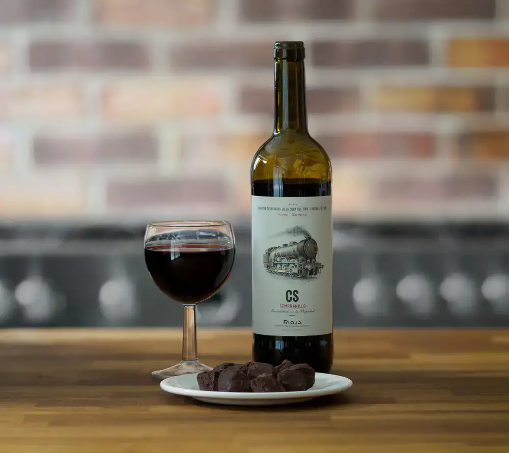 Chocolate truffles paired with wine and spirits in elegant glassware